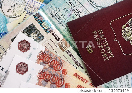 Fragment of Russian Federation visa in passport page and russian money Fragment of Russian Federation visa in passport page and russian money 139673439