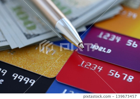 Credit cards and pen with US dollar currency money bills banknotes. Business, financial operations Credit cards and pen with US dollar currency money bills banknotes. Business, financial operations 139673457