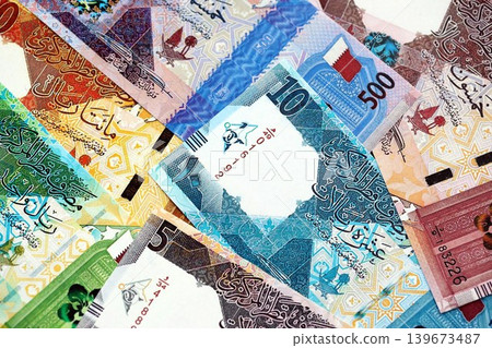 Qatari riyal money bills banknotes lies in big pile on table. Finances and business in Qatar Qatari riyal money bills banknotes lies in big pile on table. Finances and business in Qatar 139673487
