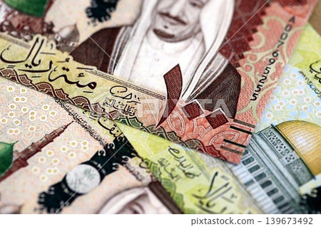 Saudi Arabia riyal money bills banknotes lies in big pile on table. Business in Saudi Arabia Saudi Arabia riyal money bills banknotes lies in big pile on table. Business in Saudi Arabia 139673492