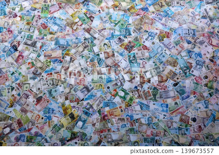Many banknotes of different currency. Big amount of random money bills close up Many banknotes of different currency. Big amount of random money bills close up 139673557
