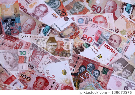 Various currencies money bills banknotes in red color. Many cash bills Various currencies money bills banknotes in red color. Many cash bills 139673576