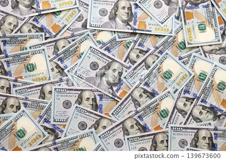 Stacks of hundred dollar bills showcase intricate designs on a flat surface. Money background Stacks of hundred dollar bills showcase intricate designs on a flat surface. Money background 139673600