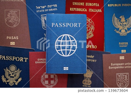 Fictional passport book travel document on big amount of real passport covers Fictional passport book travel document on big amount of real passport covers 139673604
