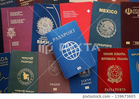 Fictional passport book travel document on big amount of real passport covers Fictional passport book travel document on big amount of real passport covers 139673605