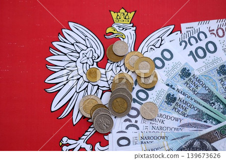 Banknotes of Polish zloty and grosz coins currency on polish flag. Poland PLN money Banknotes of Polish zloty and grosz coins currency on polish flag. Poland PLN money 139673626