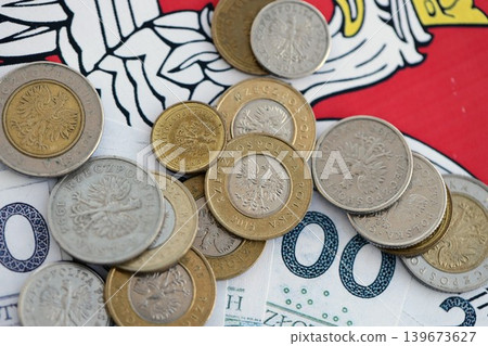 Banknotes of Polish zloty and grosz coins currency on polish flag. Poland PLN money Banknotes of Polish zloty and grosz coins currency on polish flag. Poland PLN money 139673627
