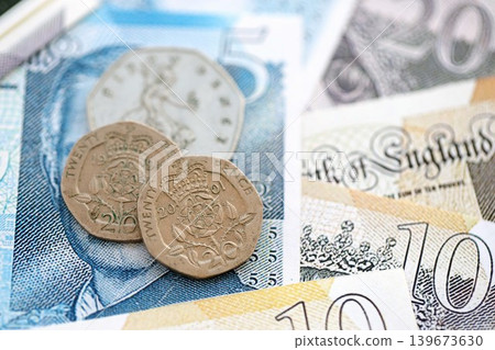Coins and banknotes of United Kingdom and Great Britain pound currency. UK money close up Coins and banknotes of United Kingdom and Great Britain pound currency. UK money close up 139673630