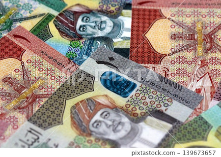 Omani rial paper banknotes pile on table. Oman OMR currency money bills in big amount Omani rial paper banknotes pile on table. Oman OMR currency money bills in big amount 139673657