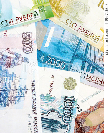 Russian ruble paper banknotes pile on table. Russia RUB currency money bills in big amount Russian ruble paper banknotes pile on table. Russia RUB currency money bills in big amount 139673669