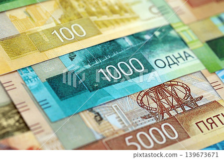 Russian ruble paper banknotes pile on table. Russia RUB currency money bills in big amount Russian ruble paper banknotes pile on table. Russia RUB currency money bills in big amount 139673671