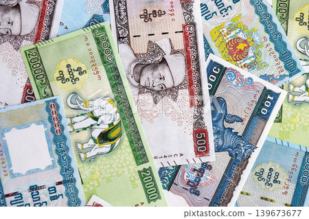 Myanmar kyat paper banknotes pile on table. Myanmar MMK currency money bills in big amount Myanmar kyat paper banknotes pile on table. Myanmar MMK currency money bills in big amount 139673677