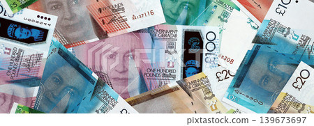 Gibraltar pound paper banknotes pile on table. Gibraltar GIP currency money bills in big amount Gibraltar pound paper banknotes pile on table. Gibraltar GIP currency money bills in big amount 139673697