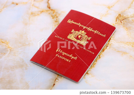 Myanmar passport on table close up. Official identification document book for citizens of Myanmar Myanmar passport on table close up. Official identification document book for citizens of Myanmar 139673700