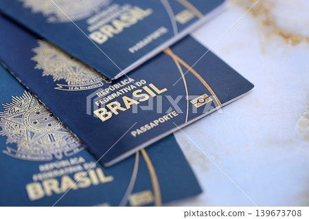 Three brazilian passports on table. Official identification document books for citizens of Brazil Three brazilian passports on table. Official identification document books for citizens of Brazil 139673708