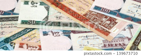 Afghan afghani paper banknotes pile on table. Afghanistan AFN currency money bills in big amount Afghan afghani paper banknotes pile on table. Afghanistan AFN currency money bills in big amount 139673710