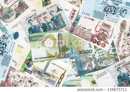 Algerian dinar paper banknotes pile on table. Algeria DZD currency money bills in big amount Algerian dinar paper banknotes pile on table. Algeria DZD currency money bills in big amount 139673711