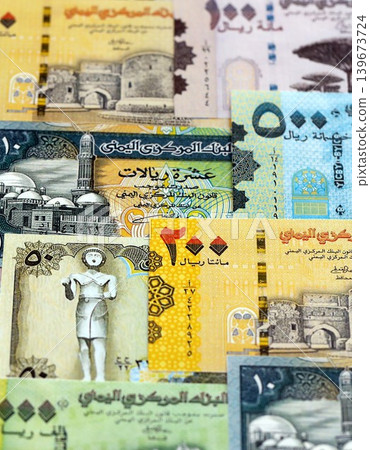 Yemeni rial paper banknotes pile on table. Yemen YER currency money bills in big amount Yemeni rial paper banknotes pile on table. Yemen YER currency money bills in big amount 139673724