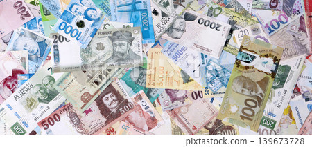 Different colorful banknotes from many various currencies of the world. Big stack of money bills 139673728