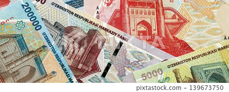 Uzbek som money bills pile on table. Uzbekistan banknotes of UZN currency close up Uzbek som money bills pile on table. Uzbekistan banknotes of UZN currency close up 139673750