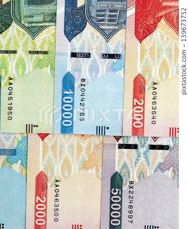 Uzbek som money bills pile on table. Uzbekistan banknotes of UZN currency close up 139673752