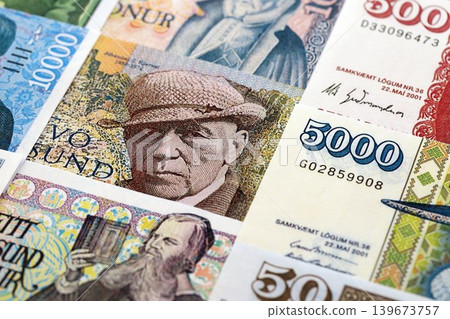 Icelandic krona money bills pile on table. Iceland banknotes of ISK currency close up Icelandic krona money bills pile on table. Iceland banknotes of ISK currency close up 139673757