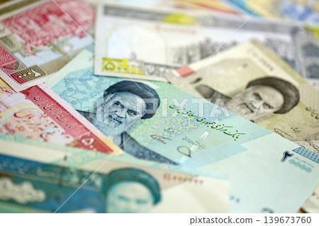 Iranian rial money bills pile on table. Iran banknotes of IRR currency close up. Concept of business Iranian rial money bills pile on table. Iran banknotes of IRR currency close up. Concept of business 139673760