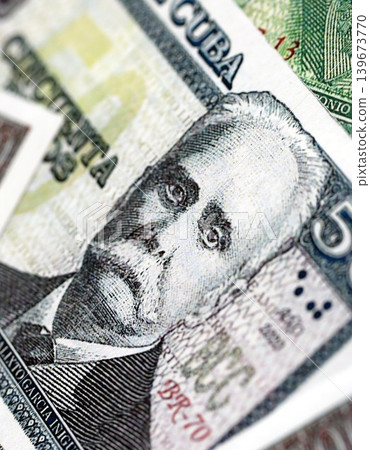 Cuban peso money bills pile on table. Cuba banknotes of CUP currency close up. Concept of business Cuban peso money bills pile on table. Cuba banknotes of CUP currency close up. Concept of business 139673770