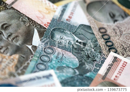 Cambodian riel money bills pile on table. Cambodia banknotes of KHR currency close up Cambodian riel money bills pile on table. Cambodia banknotes of KHR currency close up 139673775