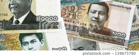 Cambodian riel money bills pile on table. Cambodia banknotes of KHR currency close up 139673780