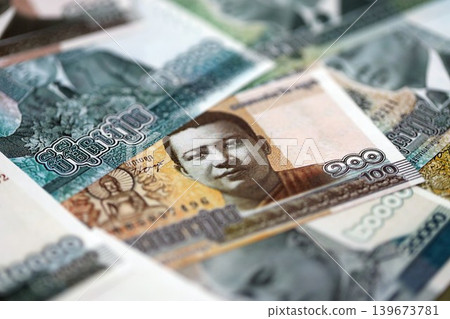 Cambodian riel money bills pile on table. Cambodia banknotes of KHR currency close up Cambodian riel money bills pile on table. Cambodia banknotes of KHR currency close up 139673781