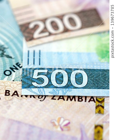 Zambian kwacha money bills pile on table. Zambia banknotes of ZMW currency close up Zambian kwacha money bills pile on table. Zambia banknotes of ZMW currency close up 139673785