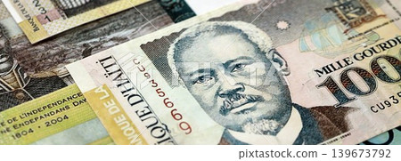 Haitian gourde money bills pile on table. Haiti banknotes of HTG currency. Concept of business Haitian gourde money bills pile on table. Haiti banknotes of HTG currency. Concept of business 139673792