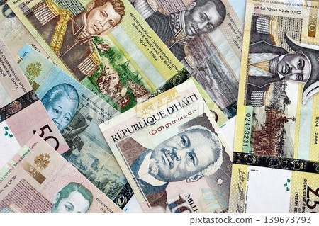 Haitian gourde money bills pile on table. Haiti banknotes of HTG currency. Concept of business Haitian gourde money bills pile on table. Haiti banknotes of HTG currency. Concept of business 139673793