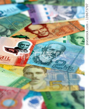 Costa Rican colon money bills pile on table. Costa Rica banknotes of CRC currency close up Costa Rican colon money bills pile on table. Costa Rica banknotes of CRC currency close up 139673797