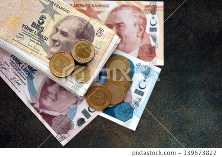 Turkish lira money bills and kurus coins pile on table. Turkey coins on banknotes of TRY currency Turkish lira money bills and kurus coins pile on table. Turkey coins on banknotes of TRY currency 139673822