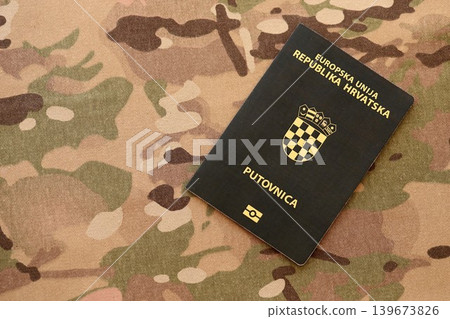 Croatian passport on table close up. Official identification document book for citizens of Croatia Croatian passport on table close up. Official identification document book for citizens of Croatia 139673826