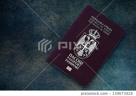 Serbian passport on table close up. Official identification document book for citizens of Serbia Serbian passport on table close up. Official identification document book for citizens of Serbia 139673828