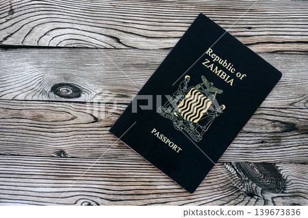 Zambian passport on table close up. Official identification document book for citizens of Zambia Zambian passport on table close up. Official identification document book for citizens of Zambia 139673836