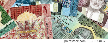 Omani rial paper banknotes pile on table. Oman OMR currency money bills in big amount Omani rial paper banknotes pile on table. Oman OMR currency money bills in big amount 139673837