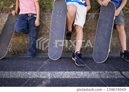 Kids, friends and skateboard for outdoor relax or exercise sneakers for workout, balance or city street. People, legs and neighbourhood wall rest or fitness on road or transport, practice or urban Kids, friends and skateboard for outdoor relax or exercise sneakers for workout, balance or city street. People, legs and neighbourhood wall rest or fitness on road or transport, practice or urban 139674049