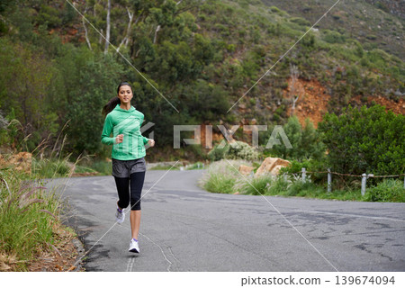 Running, fitness and woman on road on mountain for training, workout and exercise outdoors. Sports, nature and person on street for competition, race and challenge for health, wellness and cardio 139674094