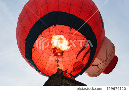 Hot air balloon with flame burning in the night Hot air balloon with flame burning in the night 139674120