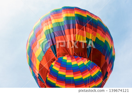 Colorful hot air balloon floating in blue sky Colorful hot air balloon floating in blue sky 139674121