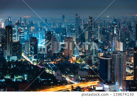 Cityscape of modern Bangkok city with illuminated skyscraper building and rush traffic on expressway Cityscape of modern Bangkok city with illuminated skyscraper building and rush traffic on expressway 139674130