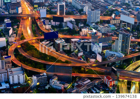 Cityscape of modern Bangkok city with illuminated skyscraper building and rush traffic on expressway Cityscape of modern Bangkok city with illuminated skyscraper building and rush traffic on expressway 139674138