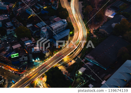 Light on expressway passing crowded downtown during dawn 139674139