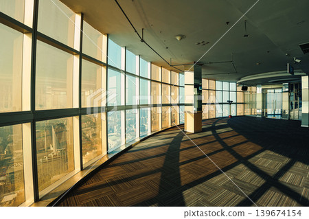 Modern futuristic observation deck with geometric pattern and symmetry glass windows in famous highrise building at Bangkok Modern futuristic observation deck with geometric pattern and symmetry glass windows in famous highrise building at Bangkok 139674154