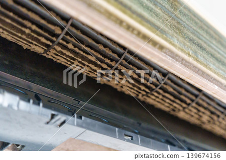 Remove and cleaning dirty air conditioner with dust covered fan blades and coils Remove and cleaning dirty air conditioner with dust covered fan blades and coils 139674156