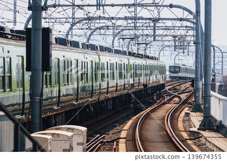 Electric railway train with metal structure and tracks arrival to station at Kyoto Electric railway train with metal structure and tracks arrival to station at Kyoto 139674355